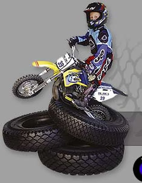 Dobový motiv z webu pneu-tyres.cz z roku 2003 — motokrosový jezdec na stohu pneumatik